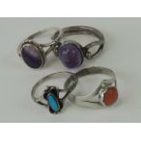 Three silver rings; a sterling silver and turquoise ring size I and two rings set with amethyst,