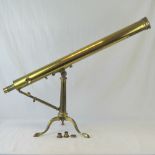 A good late 19th century brass telescope with folding tripod stand,