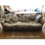 A very large three seater Knoll type sofa having shaped back and sides,