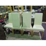 A set of six contemporary cream leatherette dining chairs.