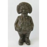 A cast metal money box in the form of a standing Golly figure with hands on waist, 15cm high.