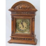 An Edwardian oak cased table clock, the