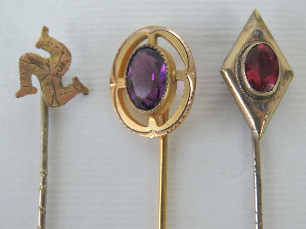 Three yellow metal tie pins, one of diam