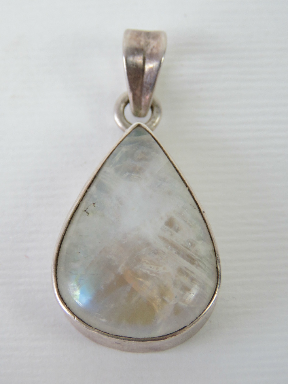 A silver teardrop shaped moonstone penda