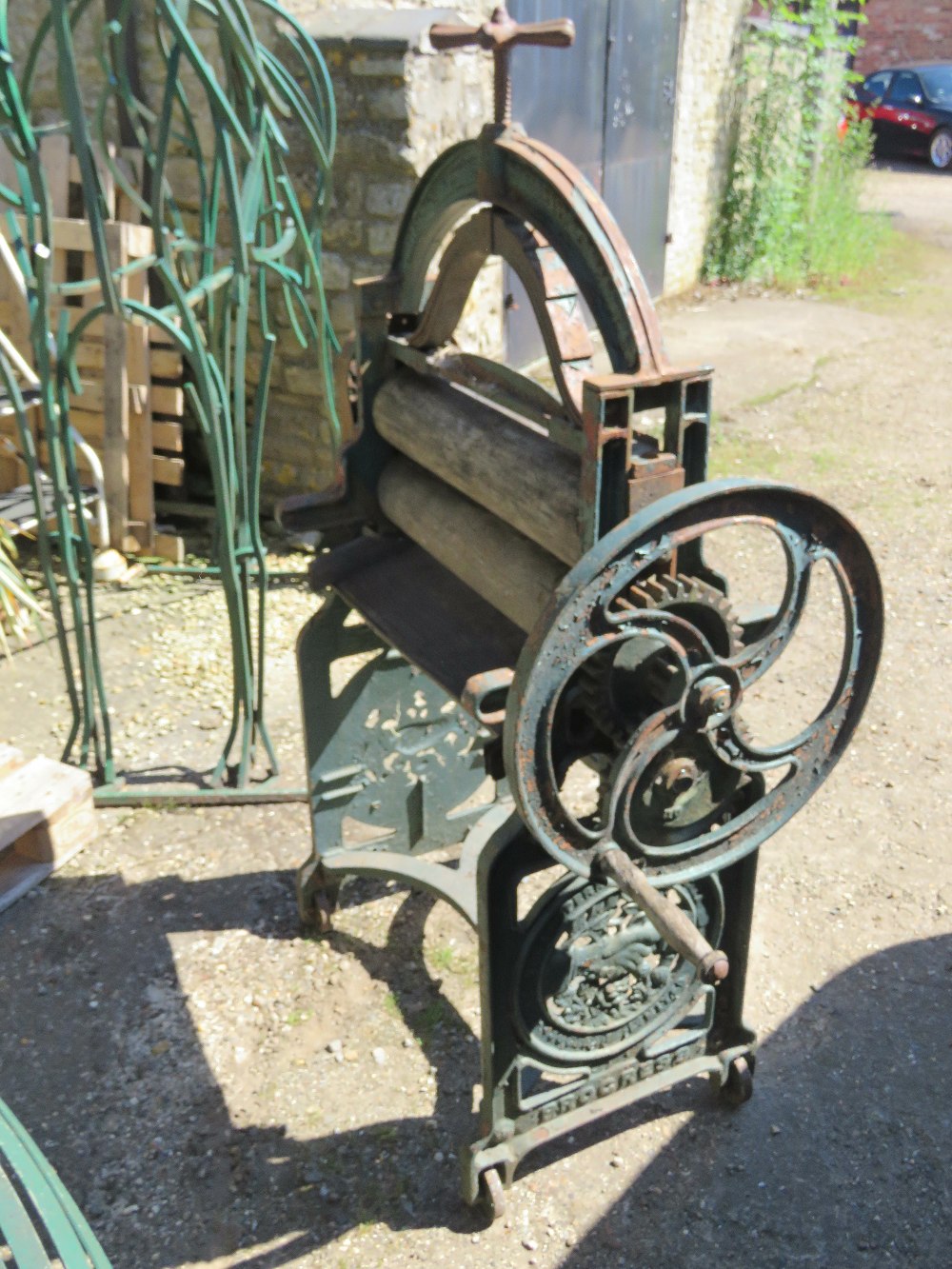 A hand cranked mangle complete with roll