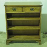 A contemporary yew wood bookcase with tw