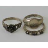 Three silver rings; a signet ring size H