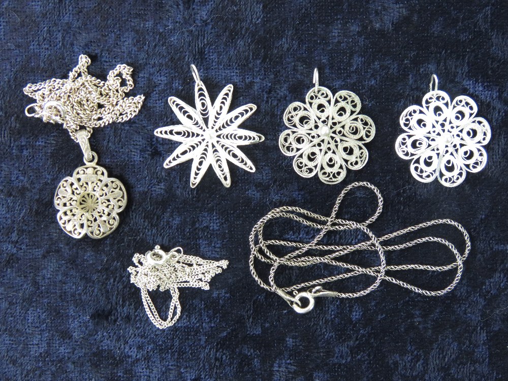 Four floral filigree pendants one marked