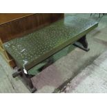 A hammered copper trellis coffee table,