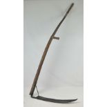 An old scythe with ash shaft and handles