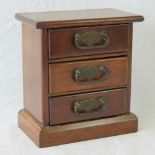 A chest of three jewellery drawers each having brass drop handle of Art Nouveau influence,