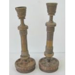 Trench art; a matched pair of brass candlesticks made from 'spare parts',