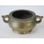 A Chinese brass censor having twin handles, single foot and six character mark to base, 17.5cm wide.