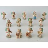 A vintage handpainted miniature German thirteen piece marching band bearing labels 'Erzgebirgische