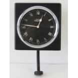 A British Jaeger 8 day car clock having black dial with Roman numerals and white painted hands.