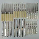 Two sets of six cake knives and forks each having HM silver collars,