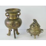 A Chinese brass censor having inlaid floral design and raised over three shaped feet, 16cm high,