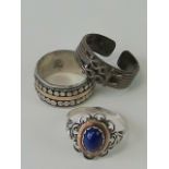 Five silver rings; one hallmarked with white stones in a diamond shape, size O-P,