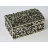 A white metal jewellery box, lid lifting to reveal black velvet liner compartment, 8 x 5.2cm.