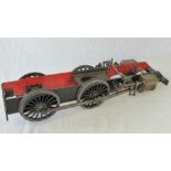 A scale model steam locomotive wheel base having two pairs of wheels, driving piston to each side,