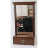 A mahogany framed hanging wall mirror fitted with a base drawer, 43cm wide, 83cm high.