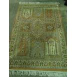 A washed Chinese beige ground rug having floral motifs, 180 x 120cm approx.