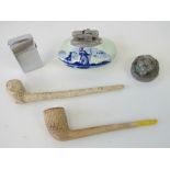 Two clay pipes together with a white metal snuff box having lion head emblem upon,