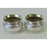 A pair of Victorian HM silver salts having undulating beaded edge and engraved leaf pattern upon,