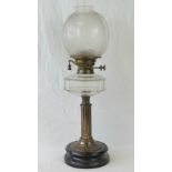A brass oil lamp having clear glass reservoir, frosted glass shade,