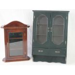 Two small modern wall cabinets, both with glazed doors and the larger fitted with two drawers.