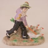 A Sitzendorf porcelain figure of a boy herding geese,