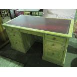A contemporary pine kneehole desk having central drawer, three graduated drawers to each side,