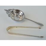 A pair of silver sugar tongs bearing partial hallmark (lion passant with makers mark for John James