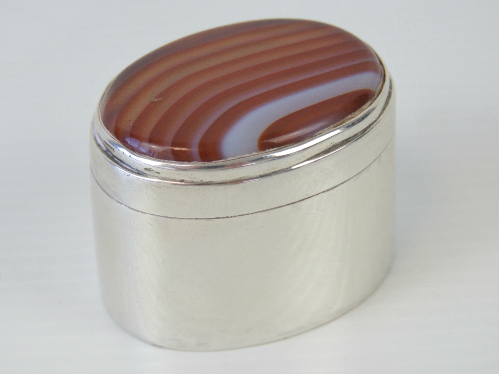 A delightful HM silver pill box having oval banded agate cabachon to the lid,