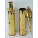 A pair of brass shell cases each bearing broad arrow upon, 31cm high.