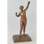 A copper patinated figure of a youth in sporting attire, stanidn 33cm high.