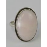 A silver and banded rose quartz ring, large central cabachon approx 2.3 x 1.