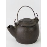 An antique cast bronze Oriental kettle with swing lid, all standing 8cm high.