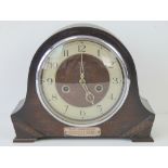 A Smith Enfield wooden cased mantle clock having silvered chapter ring and pierced hands behind