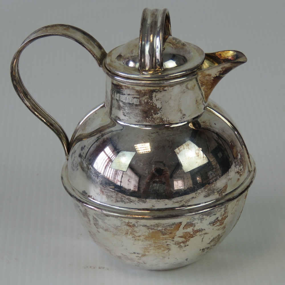 A HM silver Jersey cream jug with lid, standing 10.5cm high, hallmarked Birmingham 1975, 3.44ozt.