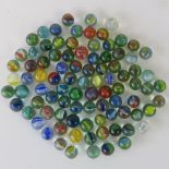 A collection of ninety vintage cats eye glass marbles.