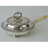 A superb silver plated lidded chaffing dish having internal triform divider and turned ivory handle,