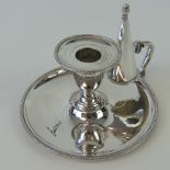 A silver plated chamber stick complete with candle snuffer,