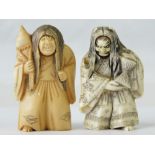 A pair of 19th century carved ivory netsuke figurines each in the form of a double-faced deity,