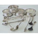A set of four HM silver napkin rings having engraved floral pattern and crimped rims,