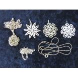 Four floral filigree pendants one marked Sterling, with three silver chains.
