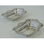 A pair of HM silver bonbon dishes having pierced gallery and repoussé floral edge,