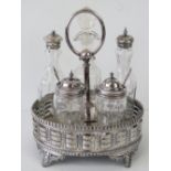 A Victorian silver plated cruet of oval design, raised upon four feet,
