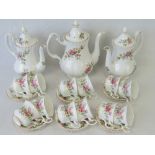 Three Royal Albert Moss Rose pattern coffee pots with twelve matching coffee cups and saucers.