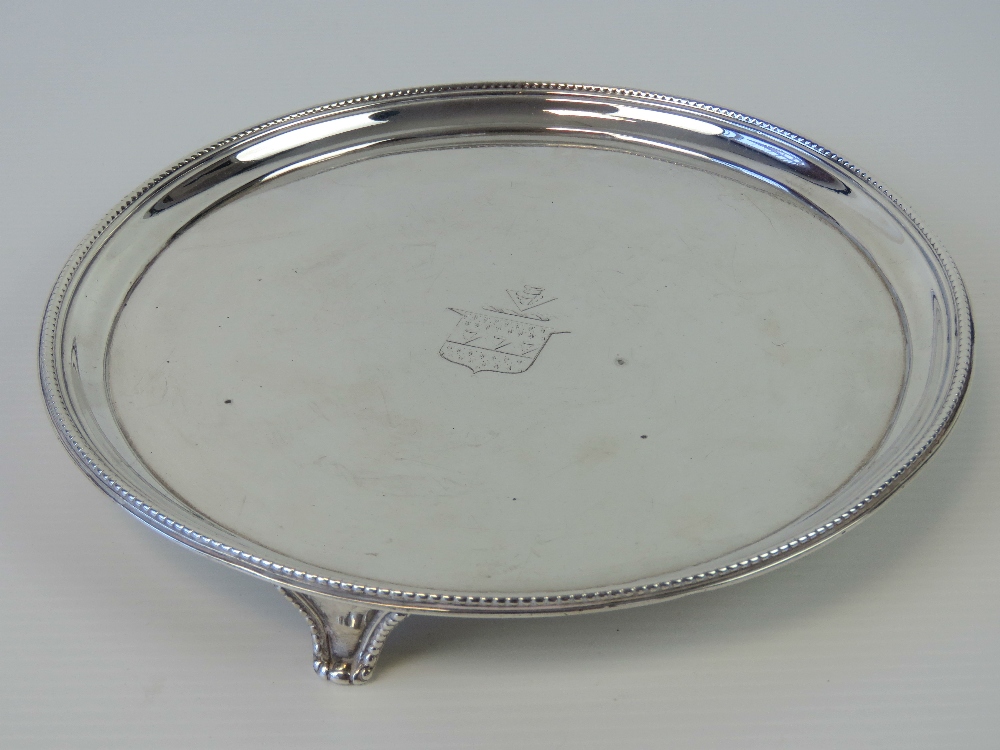 A Georgian HM silver salver raised over three shaped feet,